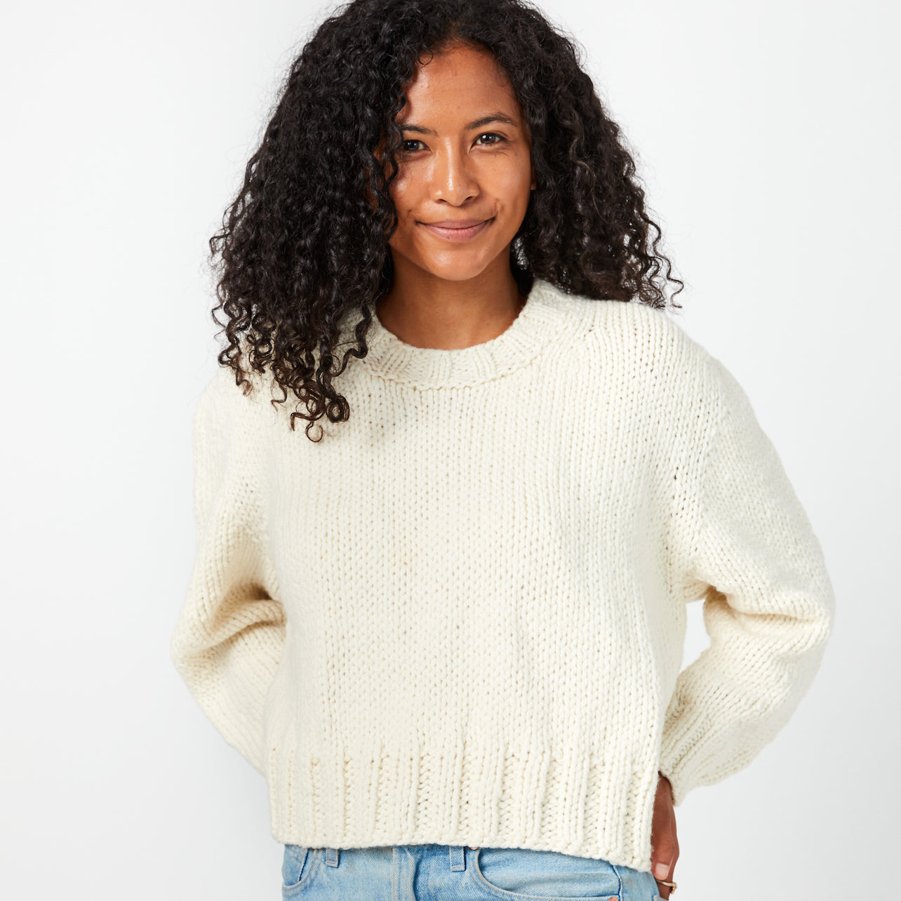 model wears handknit sweater Mabel by Cocoknits. yarn is Bread & Butter Bun.