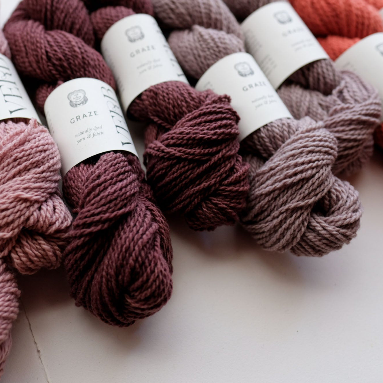 Bundles of yarn with labels on a light surface