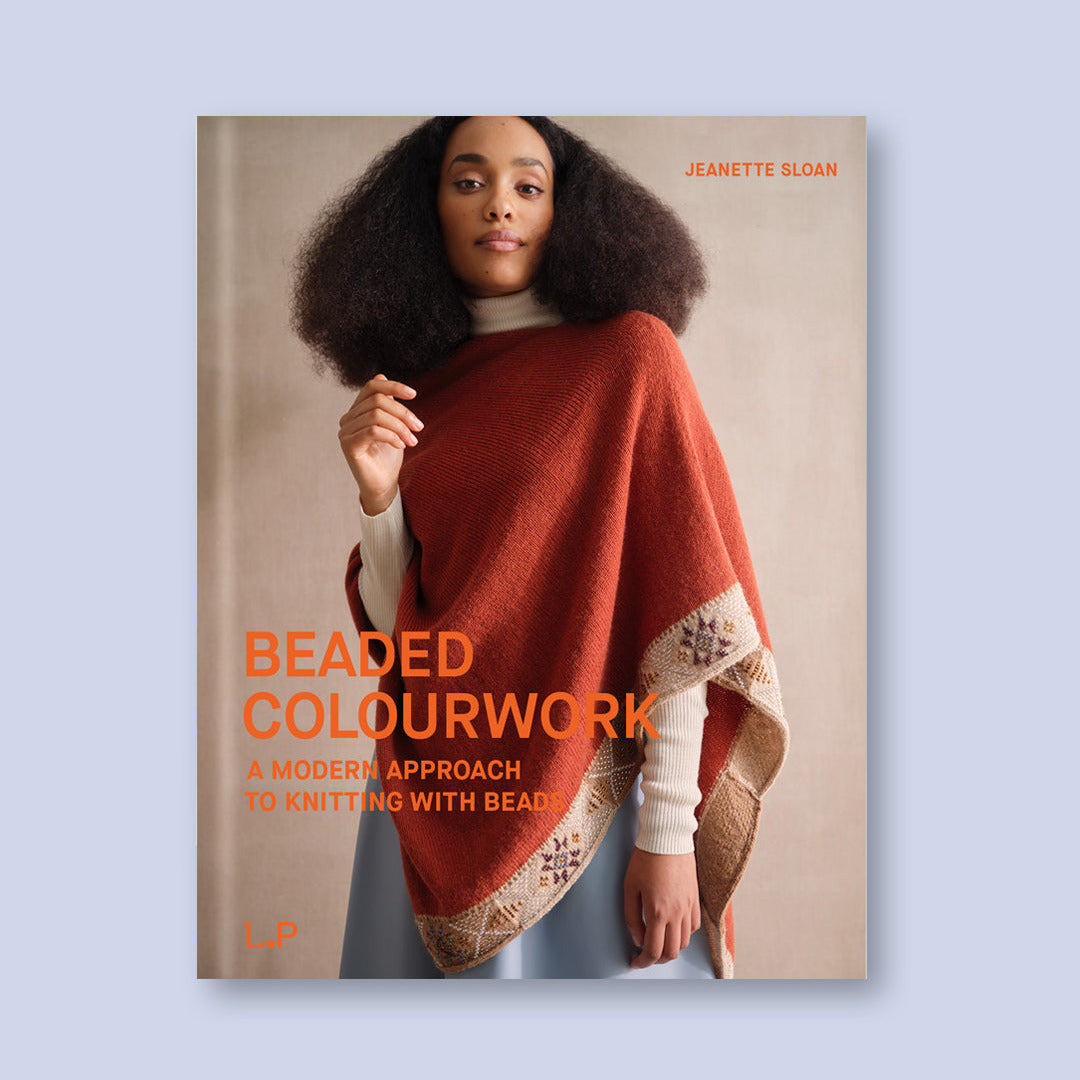Book cover of 'Beaded Colourwork' by Jeanette Sloan featuring a person wearing a red poncho with bead details.