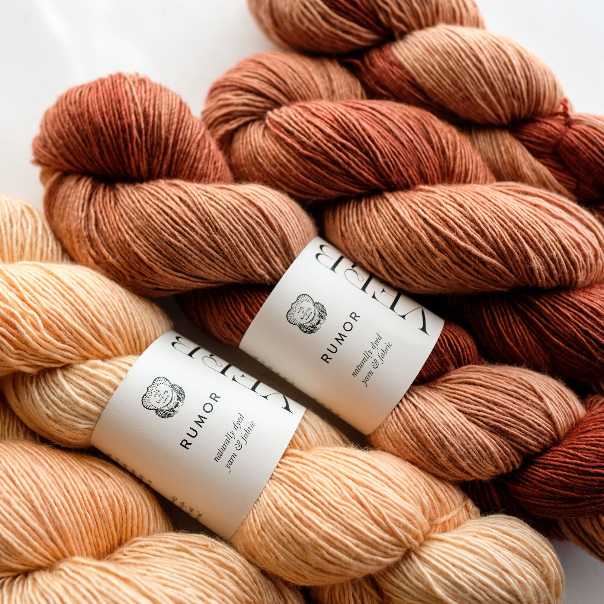 Bundles of multicolored yarn with labels on a white background
