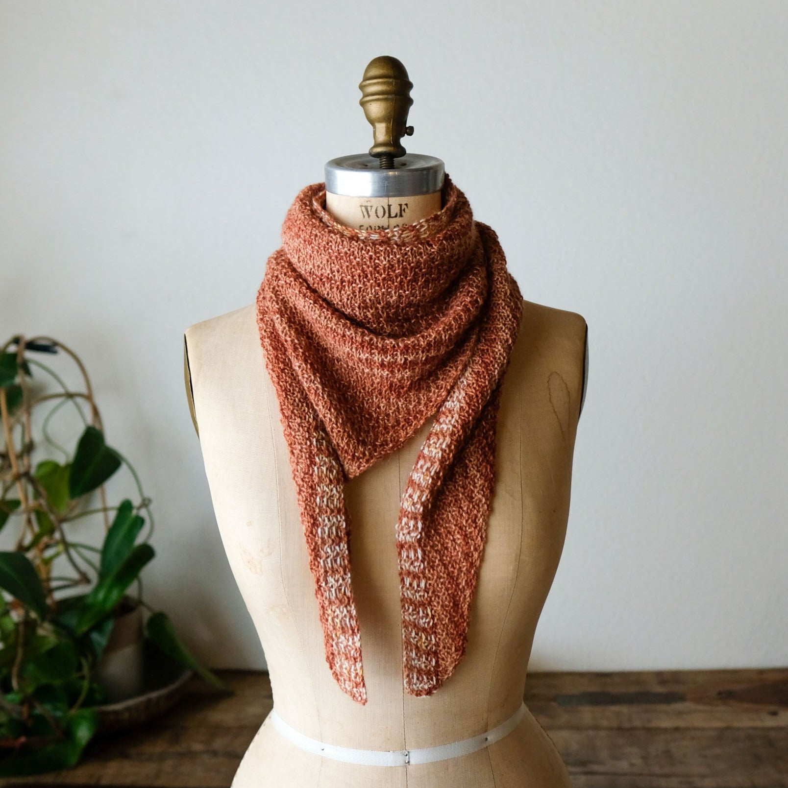 Knitted scarf on a mannequin with a white background