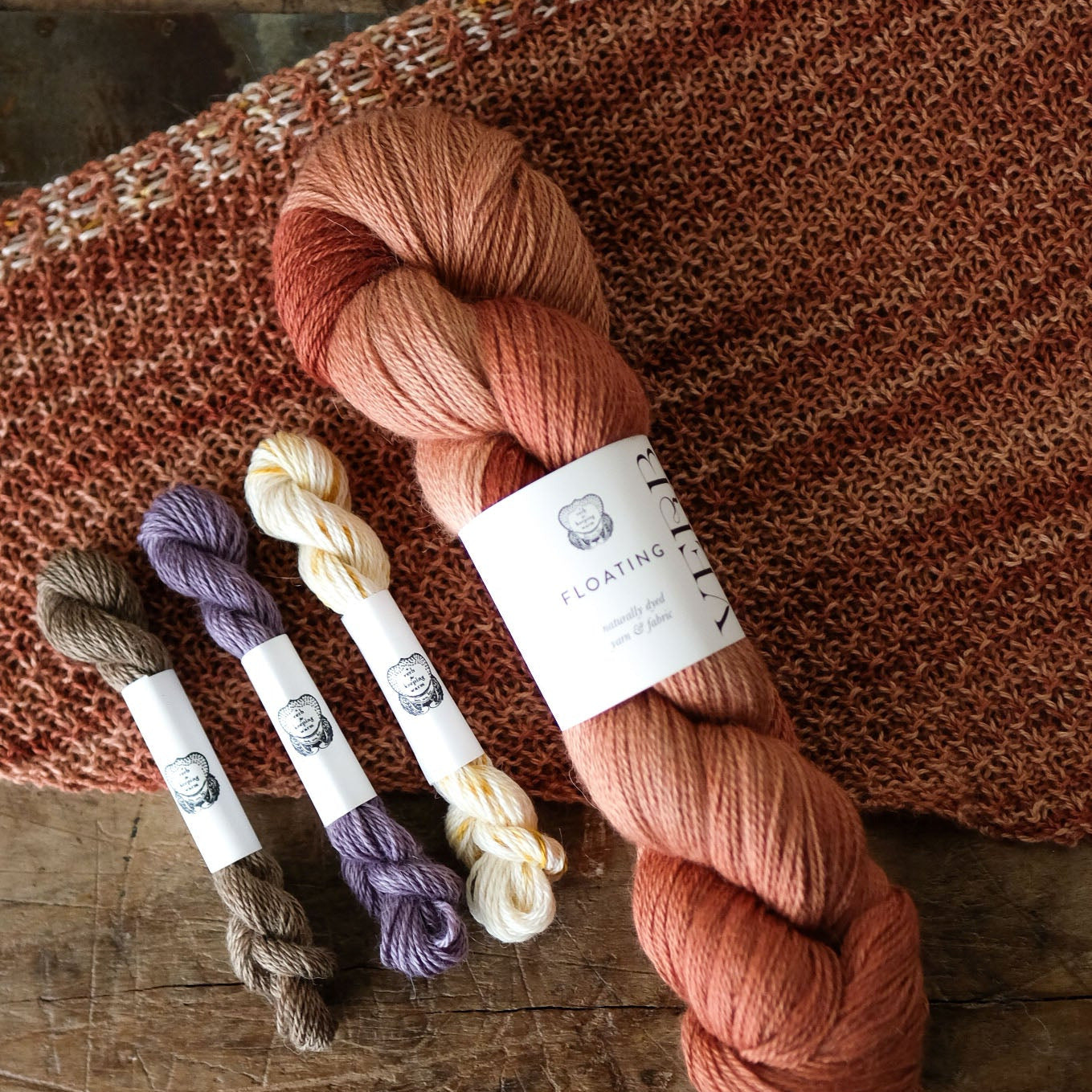 Set of yarn skeins on a textured fabric background