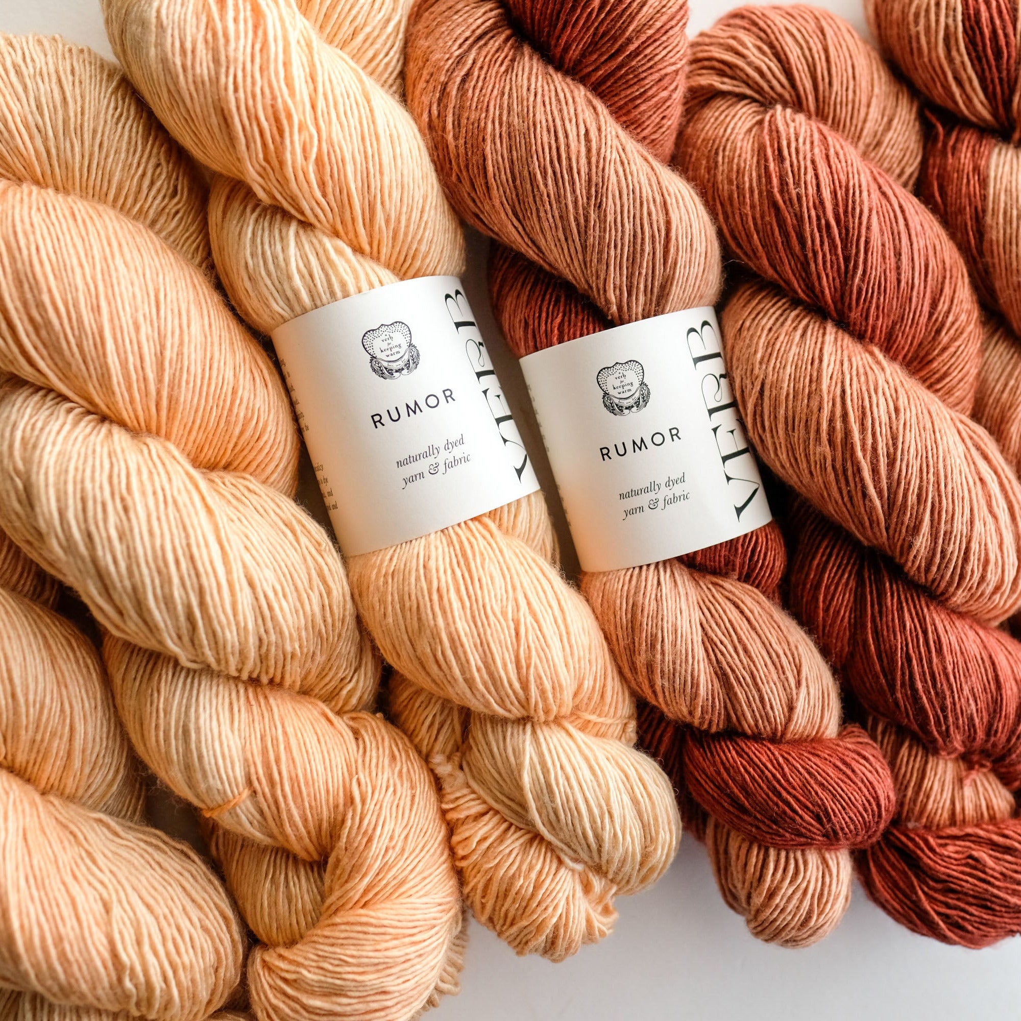 Three skeins of yarn in peach, brown, and red tones with 'Rumor' labels on a white background.