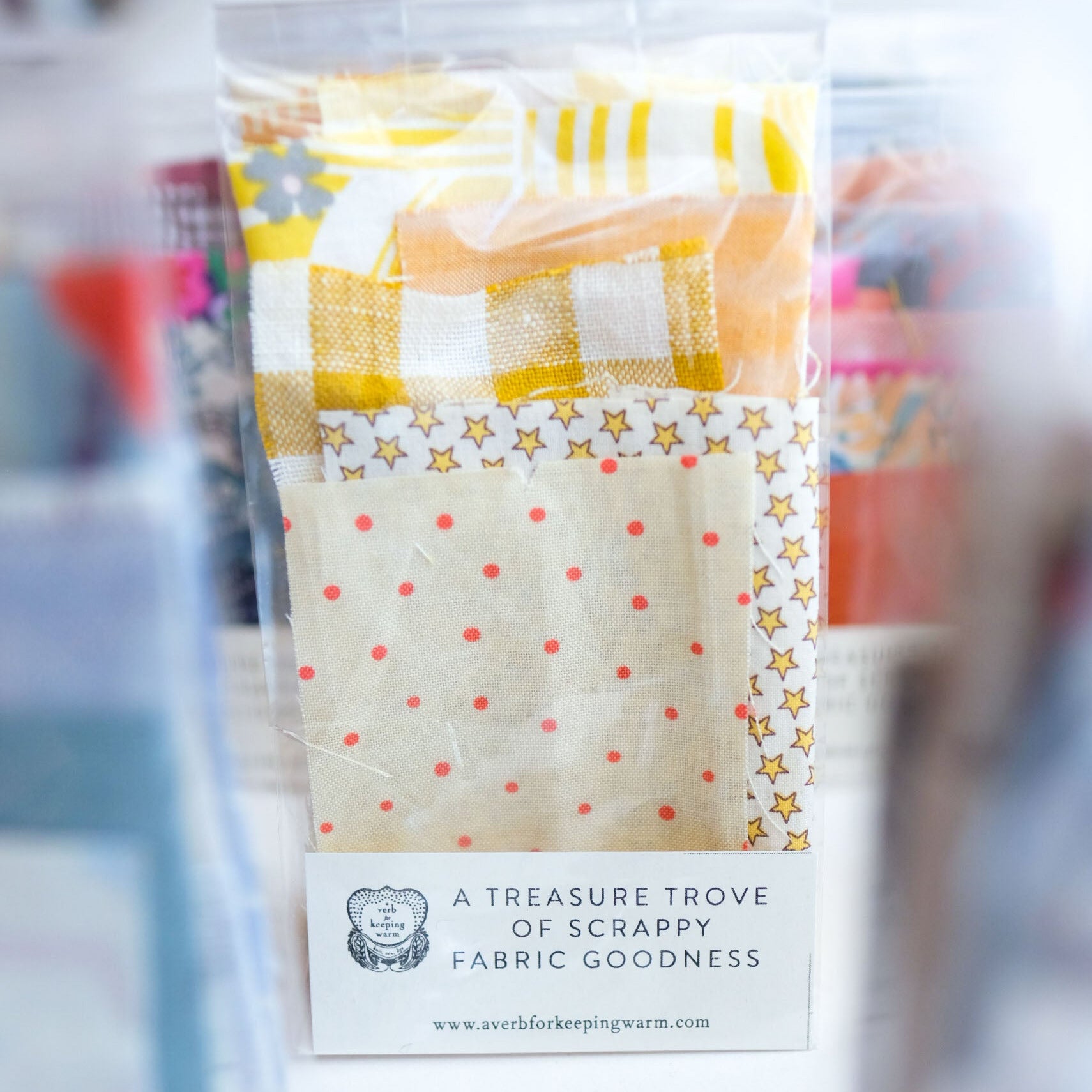 Packaged fabric samples with visible branding on a blurred background