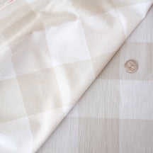 label: taupe and white check
